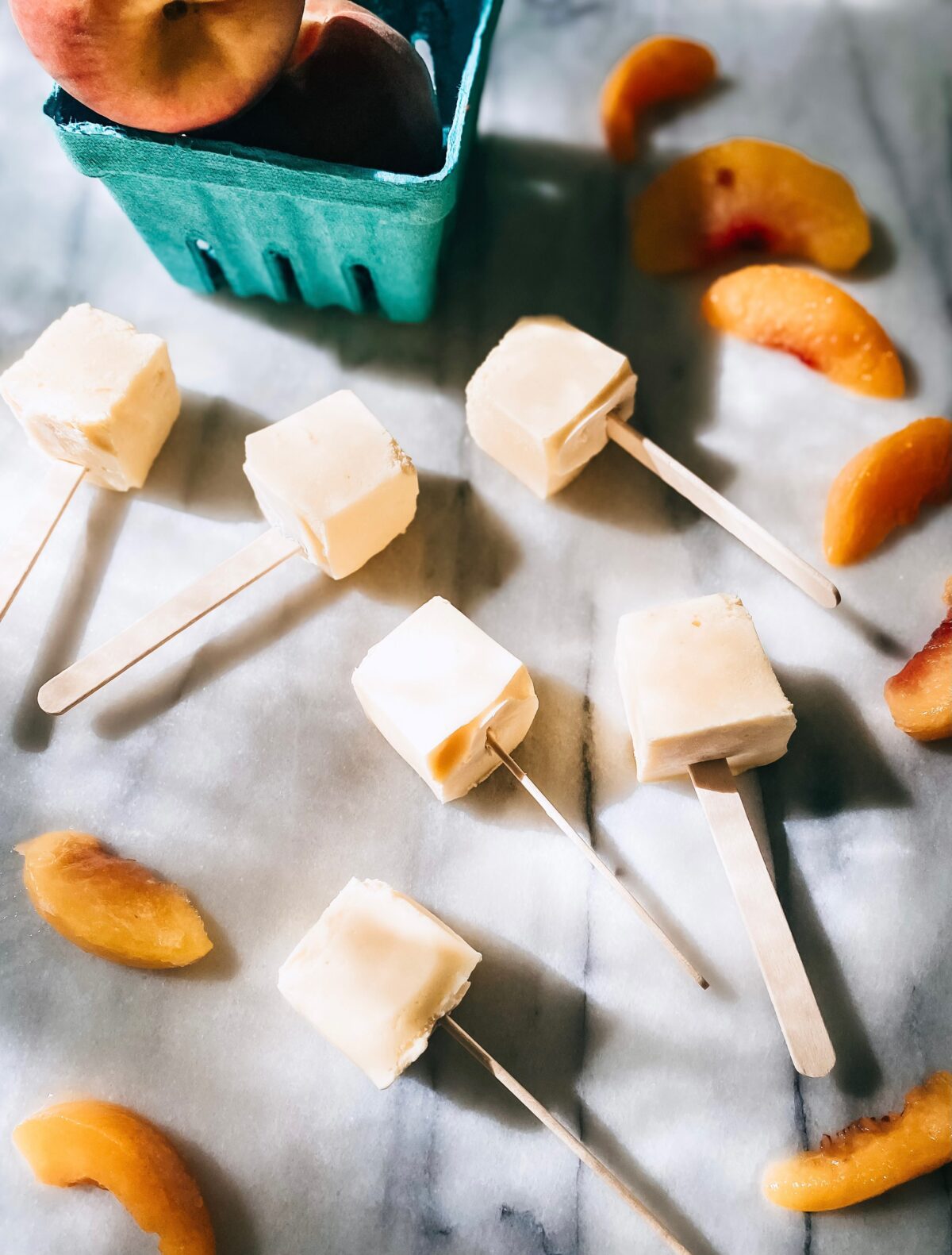 homemade peach pops on marble countertop
