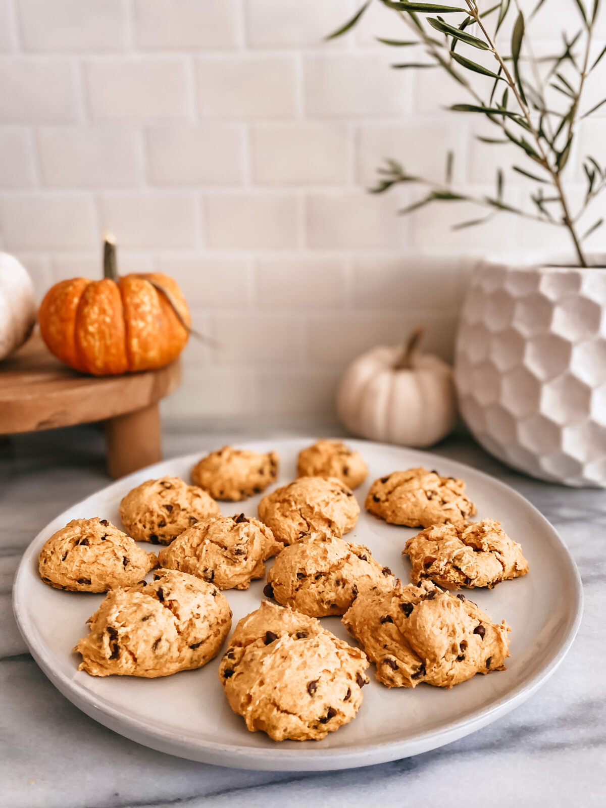 platter of 3 ingredient pumpkin chocolate chip cookies with pumpkins in background
