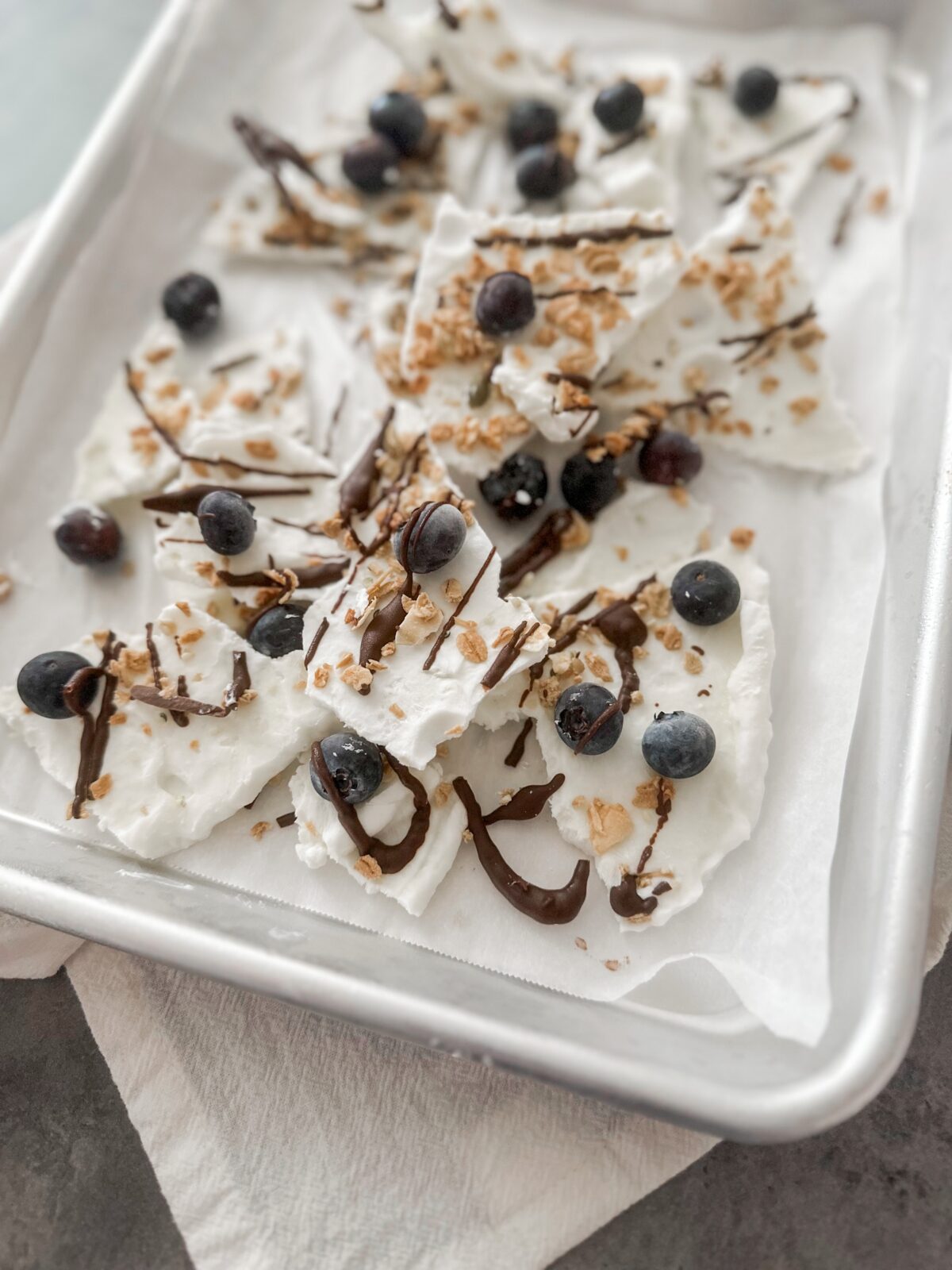 a sheet pan with a pile of yogurt bark sitting on counter
